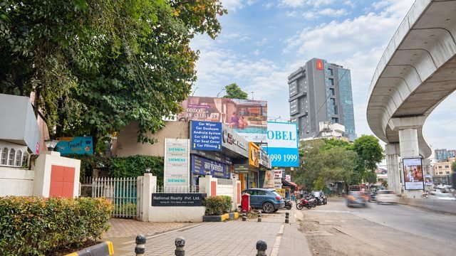The building's Baner Road frontage, with the Metro Line 3 viaduct running alongside.