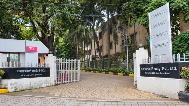 Gated entrance off Baner Road with the floor directory board and Knight Frank site office.